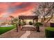 Beautiful backyard featuring a spa under a pergola, lush landscaping, and a refreshing trampoline at 14760 E Paradise Dr, Fountain Hills, AZ 85268