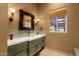 Elegant bathroom features a decorative mirror, stylish lighting and a glass bowl sink at 14760 E Paradise Dr, Fountain Hills, AZ 85268