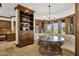 Breakfast nook features a built-in dining table, large windows, and custom wood cabinetry at 14760 E Paradise Dr, Fountain Hills, AZ 85268