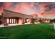 Sprawling backyard with lush green lawn, ideal for outdoor activities and relaxation at twilight at 14760 E Paradise Dr, Fountain Hills, AZ 85268