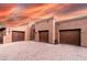 Expansive home with multiple garage doors, and desert landscaping set against a colorful sky at 14760 E Paradise Dr, Fountain Hills, AZ 85268