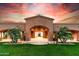 Elegant home featuring a grand arched entrance, lush landscaping, and a meticulously manicured lawn at 14760 E Paradise Dr, Fountain Hills, AZ 85268