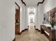 Hallway featuring wood trim, travertine floors, and views of the home's interior at 14760 E Paradise Dr, Fountain Hills, AZ 85268