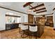Kitchen with breakfast bar, stainless steel wine refrigerator, and beautiful wooden beams at 14760 E Paradise Dr, Fountain Hills, AZ 85268