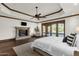 Bright and airy main bedroom with a stone fireplace and access to the outdoors at 14760 E Paradise Dr, Fountain Hills, AZ 85268