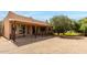 Expansive backyard featuring covered patio with railing and desert landscaping at 16222 W Augusta Ave, Litchfield Park, AZ 85340
