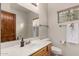 Clean bathroom with wood accents, vanity, and modern fixtures at 16222 W Augusta Ave, Litchfield Park, AZ 85340