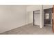 Neutral bedroom featuring sliding closet doors and neutral carpet in a well-lit space at 16222 W Augusta Ave, Litchfield Park, AZ 85340