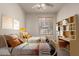 Bright bedroom featuring stylish decor, twin beds, and shelving at 16222 W Augusta Ave, Litchfield Park, AZ 85340