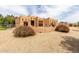 Southwestern-style home displaying appealing architecture, gravel landscaping and manicured yard at 16222 W Augusta Ave, Litchfield Park, AZ 85340