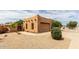 Exterior view of the home showcasing its southwest architectural style, desert landscaping, and gated entrance at 16222 W Augusta Ave, Litchfield Park, AZ 85340