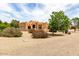 Charming Southwestern-style home with gravel landscaping and well-maintained exterior grounds at 16222 W Augusta Ave, Litchfield Park, AZ 85340