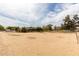 Large horse property, with sandy soil, a covered shelter, and a perimeter fence that encloses the entire acreage at 16222 W Augusta Ave, Litchfield Park, AZ 85340