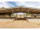 Interior of a metal roof horse shelter with partial walls and multiple pens at 16222 W Augusta Ave, Litchfield Park, AZ 85340