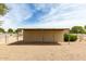 Metal structure horse shelter on a large gravel lot surrounded by trees at 16222 W Augusta Ave, Litchfield Park, AZ 85340