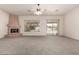 Spacious living room with a large fireplace and access to the outdoors at 16222 W Augusta Ave, Litchfield Park, AZ 85340