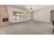 Spacious living room featuring a cozy fireplace and sliding doors that let in natural light at 16222 W Augusta Ave, Litchfield Park, AZ 85340
