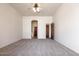 Large main bedroom with an arched doorway to the ensuite and a ceiling fan at 16222 W Augusta Ave, Litchfield Park, AZ 85340