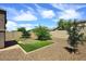 Wide angle view of the backyard featuring low maintenance desert landscaping and an artificial lawn at 16418 W Whitehorn Way, Surprise, AZ 85387