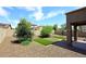 Wide angle view of the backyard featuring low maintenance desert landscaping and an artificial lawn at 16418 W Whitehorn Way, Surprise, AZ 85387