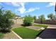 Wide angle view of the backyard featuring low maintenance desert landscaping and an artificial lawn at 16418 W Whitehorn Way, Surprise, AZ 85387