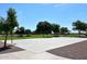 Outdoor basketball court featuring well-maintained surface, hoops, and surrounding green space, perfect for recreational games at 16418 W Whitehorn Way, Surprise, AZ 85387