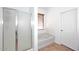 Bright bathroom features a bathtub, shower, and earth-tone tile floor at 16418 W Whitehorn Way, Surprise, AZ 85387