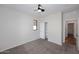 Carpeted bedroom with a closet and a ceiling fan at 16418 W Whitehorn Way, Surprise, AZ 85387
