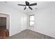 Bedroom showcasing wood-trimmed window and closet space with plush carpet and ceiling fan at 16418 W Whitehorn Way, Surprise, AZ 85387