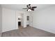 Comfortable bedroom offering carpet, a ceiling fan, and an ensuite bathroom for added convenience at 16418 W Whitehorn Way, Surprise, AZ 85387