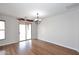 Bright dining room featuring hardwood floors, stylish light fixture, and sliding doors at 16418 W Whitehorn Way, Surprise, AZ 85387