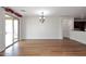 Dining area showcasing hardwood floors, stylish lighting, and access to the patio at 16418 W Whitehorn Way, Surprise, AZ 85387