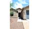 Close up of home's entrance with well-manicured landscaping leading to the front door at 16418 W Whitehorn Way, Surprise, AZ 85387