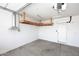 Uncluttered garage with overhead storage space, clean epoxy floor, and bright lighting at 16418 W Whitehorn Way, Surprise, AZ 85387