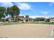 Sand volleyball court with net in place, surrounded by well-maintained landscaping and nearby homes, ideal for outdoor fun at 16418 W Whitehorn Way, Surprise, AZ 85387