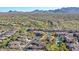 A picturesque aerial of community with vibrant landscaping, homes, a golf course, and mountain views at 19550 N Grayhawk Dr # 1039, Scottsdale, AZ 85255