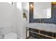 Chic powder room featuring sleek fixtures, stylish tile backsplash, and elegant marble countertop at 19550 N Grayhawk Dr # 1039, Scottsdale, AZ 85255