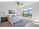 Bright bedroom with a large window that offers a view of mountains, and a calm, neutral color palette at 19550 N Grayhawk Dr # 1039, Scottsdale, AZ 85255