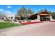 Elegant clubhouse entrance with covered parking and mature trees on meticulously landscaped grounds at 19550 N Grayhawk Dr # 1039, Scottsdale, AZ 85255