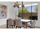 Bright dining area with modern chandelier and a large window showcasing the outside landscape at 19550 N Grayhawk Dr # 1039, Scottsdale, AZ 85255