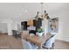 Dining space with modern light fixture and art piece adjacent to the kitchen with barstool seating at 19550 N Grayhawk Dr # 1039, Scottsdale, AZ 85255