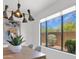 Light-filled dining area with a large window showcasing the exterior, complemented by stylish decor and furnishings at 19550 N Grayhawk Dr # 1039, Scottsdale, AZ 85255