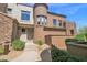 Two-story home with a turret-style design and desert landscaping at 19550 N Grayhawk Dr # 1039, Scottsdale, AZ 85255