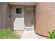 Inviting home entrance with a beige front door and manicured landscaping at 19550 N Grayhawk Dr # 1039, Scottsdale, AZ 85255