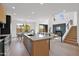 Open concept kitchen with stone countertops, stainless steel appliances, and an adjacent dining area leading into the living space at 19550 N Grayhawk Dr # 1039, Scottsdale, AZ 85255