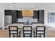 Stylish kitchen island with sleek countertops, bar stool seating, and modern cabinetry at 19550 N Grayhawk Dr # 1039, Scottsdale, AZ 85255