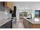 Modern kitchen featuring stainless steel appliances, island with seating, and adjacent dining area with bright window at 19550 N Grayhawk Dr # 1039, Scottsdale, AZ 85255
