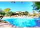 Large, inviting swimming pool with lounge chairs surrounded by lush greenery and desert landscaping at 19550 N Grayhawk Dr # 1039, Scottsdale, AZ 85255