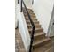 Modern staircase with wood steps and a sleek metal railing at 19550 N Grayhawk Dr # 1039, Scottsdale, AZ 85255