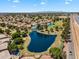 Scenic aerial view of the community featuring a lake, golf course, and residential area at 19920 N 69Th Ave, Glendale, AZ 85308